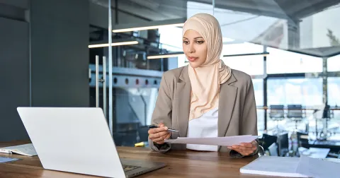 Image of hijabi women at her computer doing work