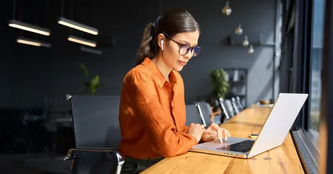 Business woman sitting at laptop