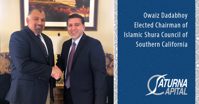 Owaiz Dadabhoy shakes hands with outgoing Shura Council Chairman Soboh